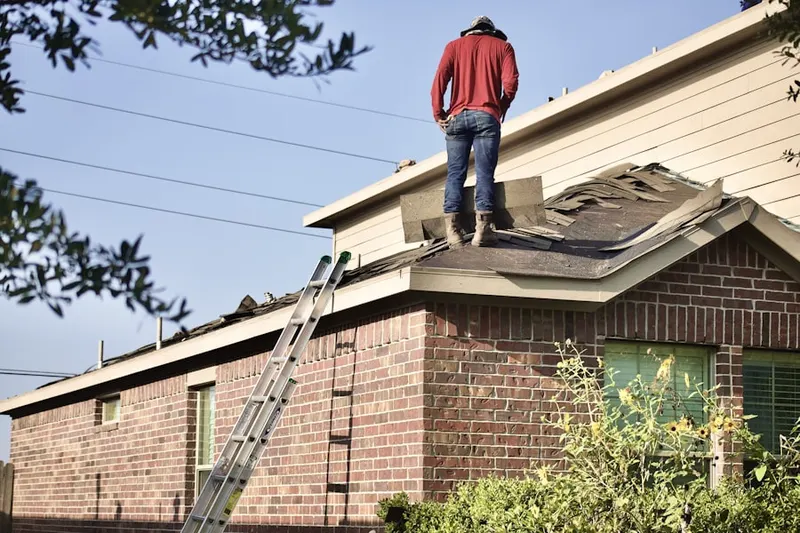 Professional roofer working on a residential roof in Nobles Crossroads